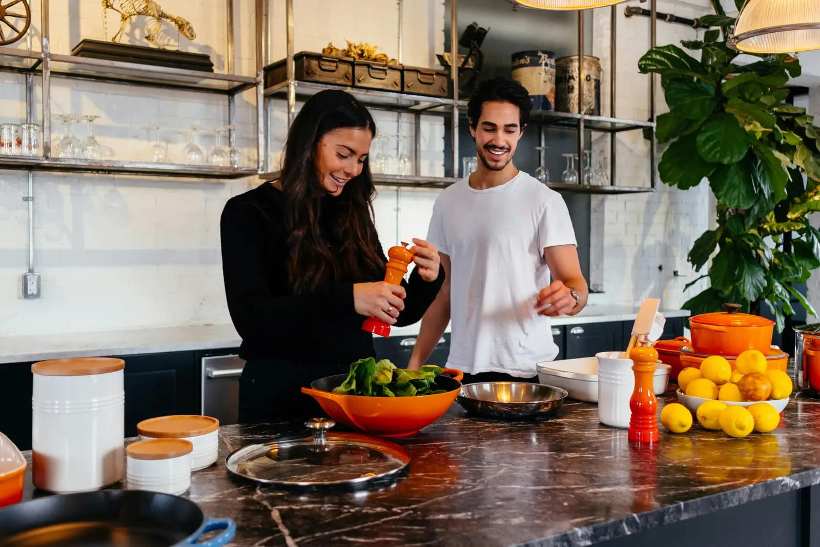 Man and woman standing at a kitchen table together