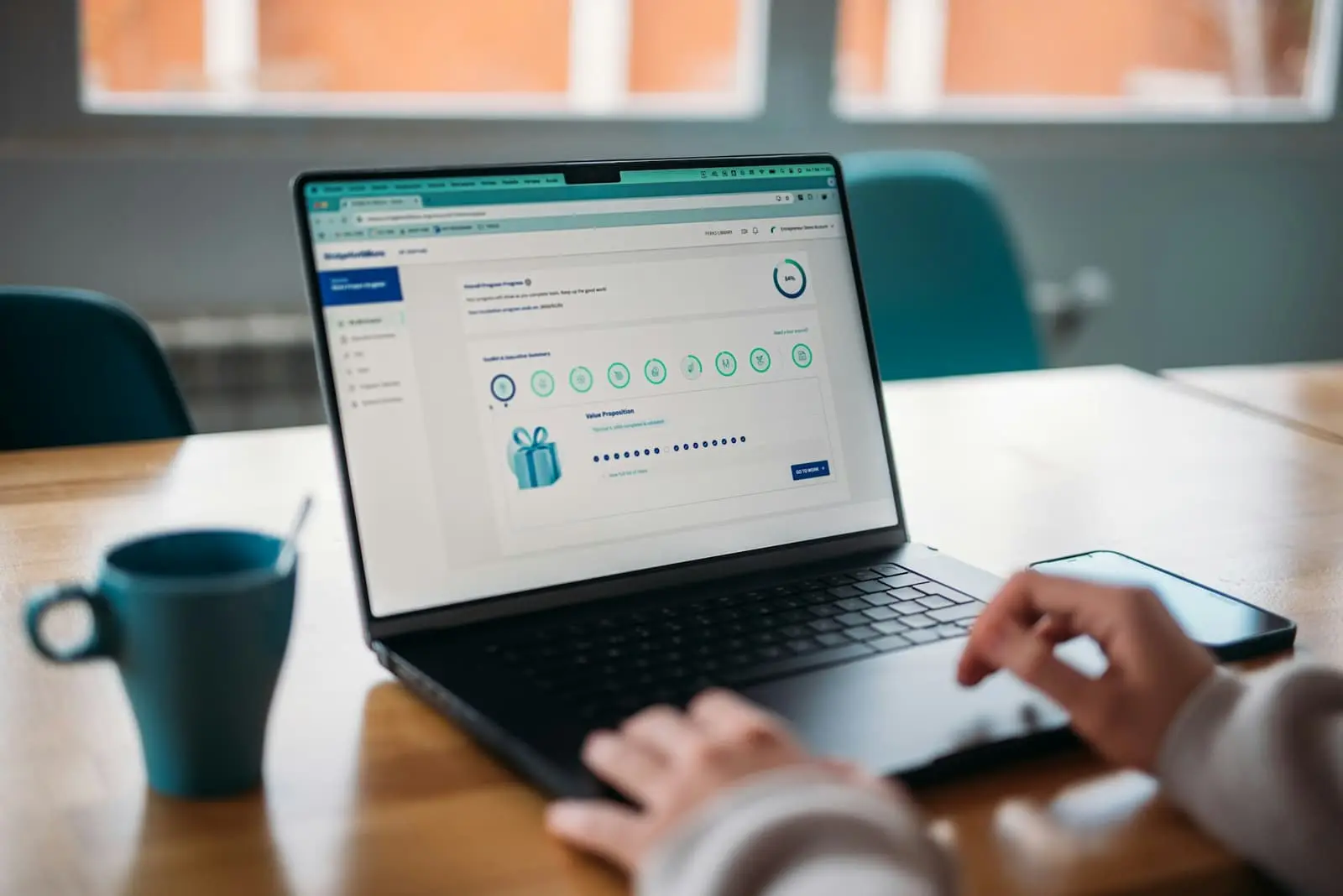 Person using a laptop to review their account information at a desk