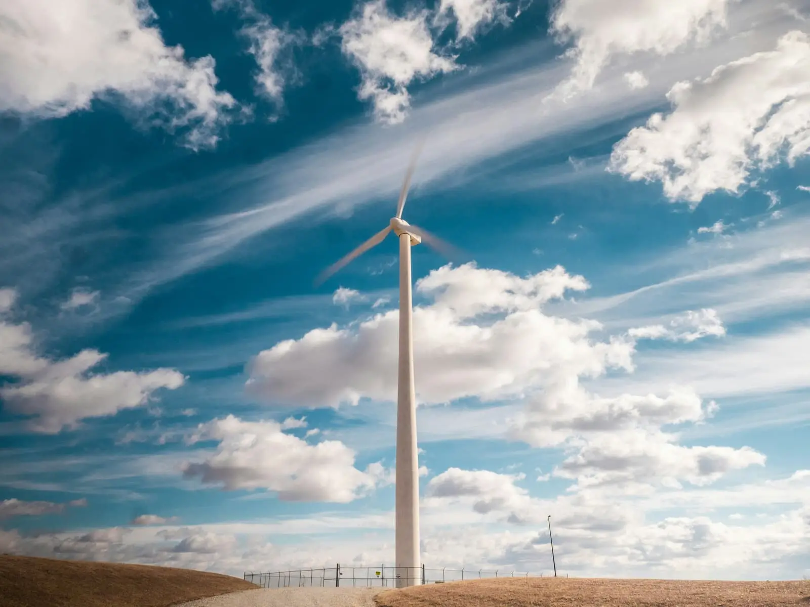 Farm windmill standing against a cloudy sky