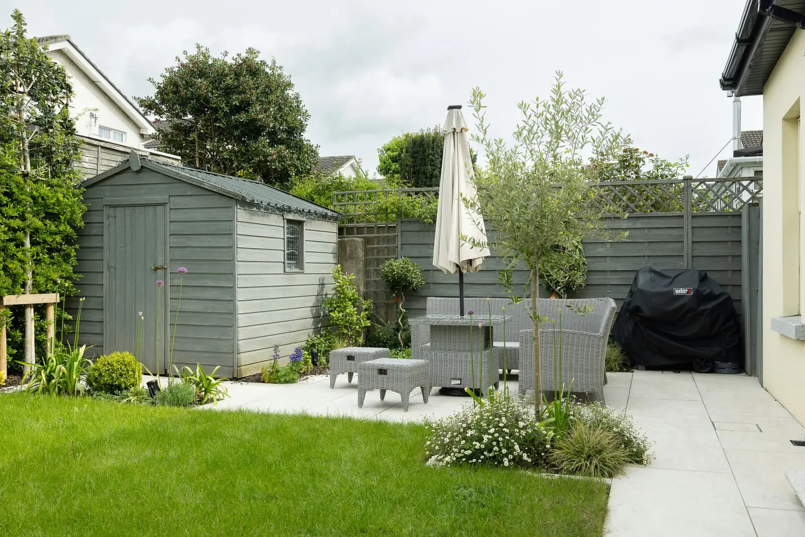 Backyard patio with a table, chairs and an umbrella
