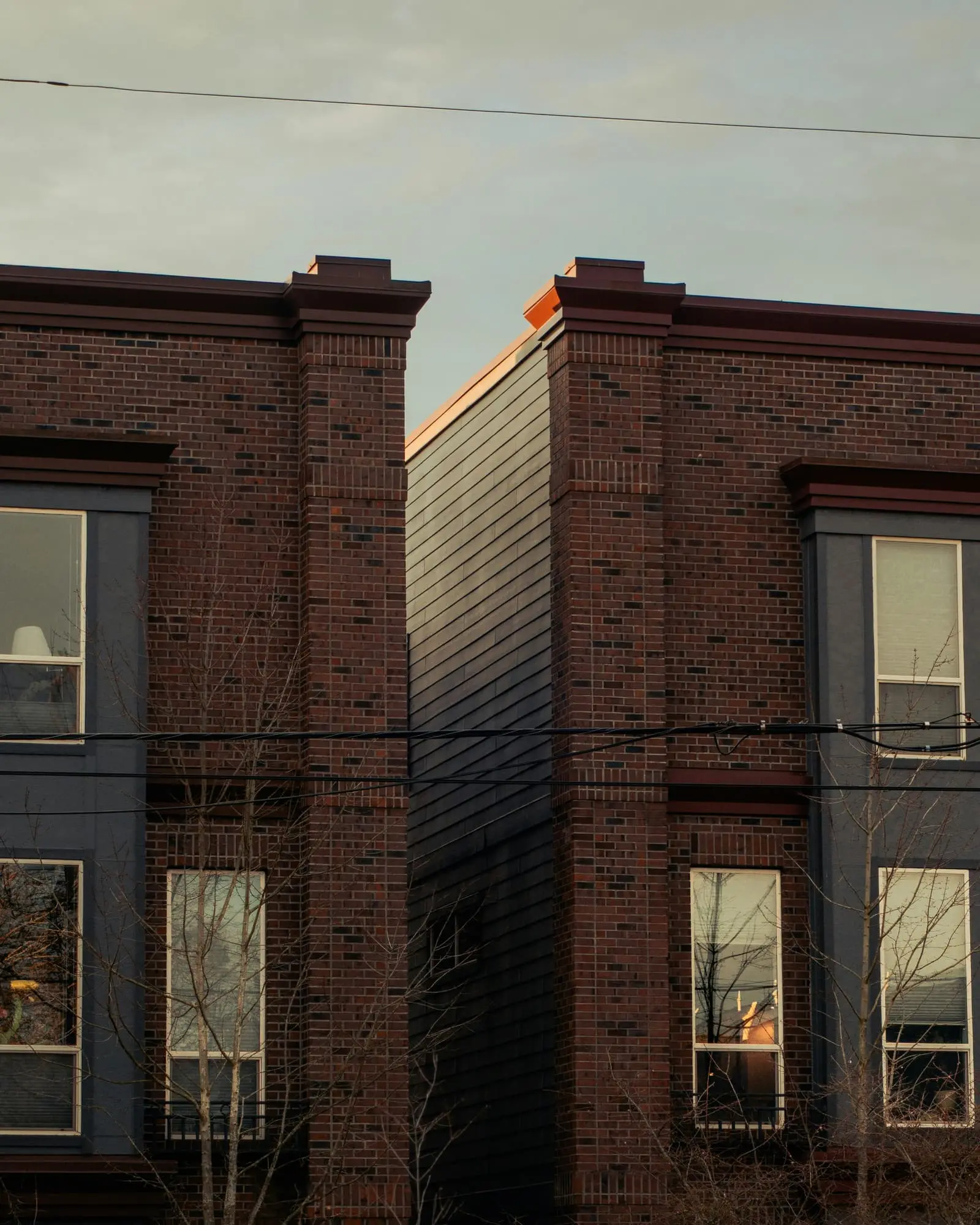 Modern townhouses with brick and blue siding details