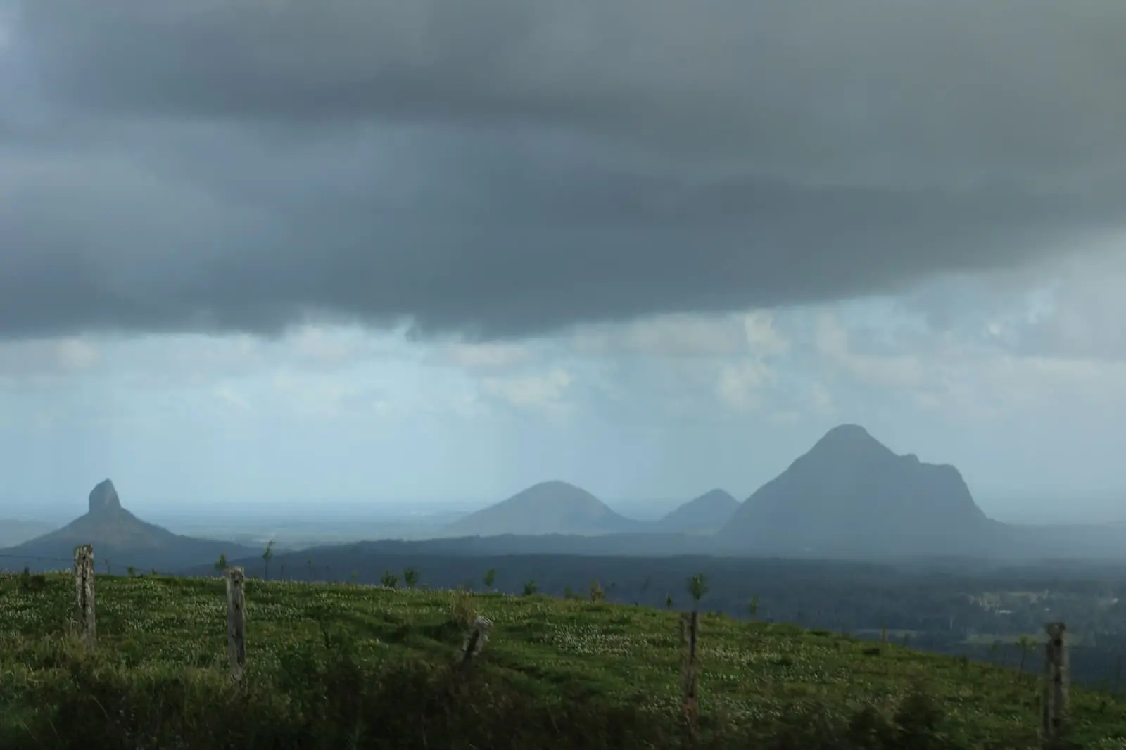 Volcanic peaks rising above a green hillside on the Sunshine Coast hinterland, Queensland (no cane fields)