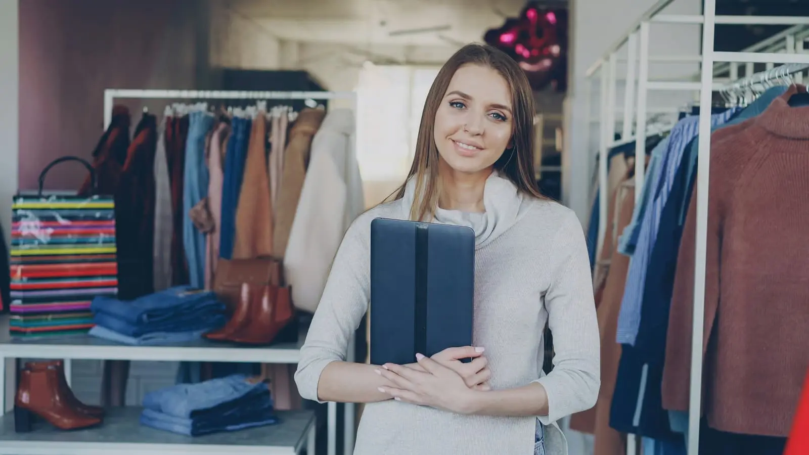 Woman standing among clothing racks in a boutique clothing store